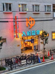 a group of bikes parked outside of a building at Katsu hotel #2 in Osaka +288 photos