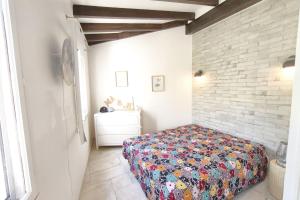 a bedroom with a bed and a brick wall at Ecological house with solar electricity in Ajaccio