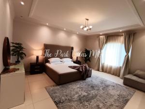 a bedroom with a bed and a sign that reads the park hotel at Affordable Luxury The Park Villas MQ Muscat in Muscat