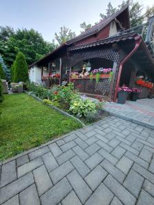 a house with a garden with flowers in a yard at Casa HAPPY in Sovata
