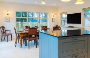 a kitchen and dining room with a table and chairs at The Old Coach House & The Hayloft in Braemar
