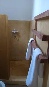 a bathroom with towels hanging on the corner of a shower at Pahali in Bwejuu