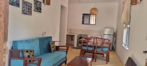 a living room with a blue couch and chairs at Pahali in Bwejuu +28 photos