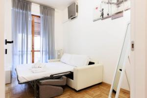 a hospital room with a bed and a chair at Florentine Touch - Orsini 76 in Florence