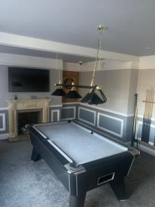 a pool table in a living room with at East Dart Inn in Yelverton