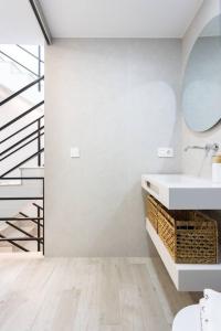 a white bathroom with a sink and a staircase at Sunnyland Teresitas beach house in San Andrés