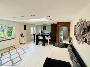 a living room with a couch and a dining room at Wohlfühloase in Hofheim in Hofheim am Taunus