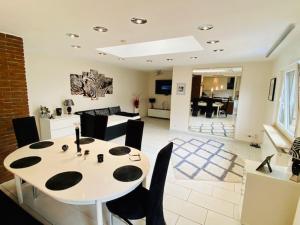 a dining room and living room with a table and chairs at Wohlfühloase in Hofheim in Hofheim am Taunus +1 photo