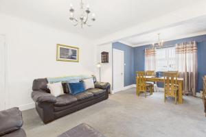 a living room with a couch and a dining room at Host & Stay - Pier View in Amble +15 photos