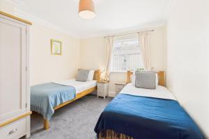 a bedroom with two beds and a window at Host & Stay - Pier View in Amble