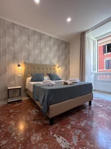 a bedroom with a large bed and a large window at Dormire in Trastevere in Rome