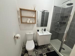 a bathroom with a toilet and a sink and a shower at Maison Delavigne in Amiens