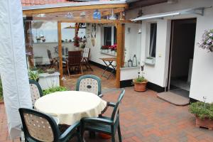 a patio with a white table and chairs at Ferienzimmer Riesebeck in Wieck