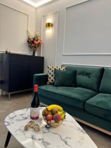 a bottle of wine and a bowl of fruit on a table at Cloè Boutique Apartment in Termoli