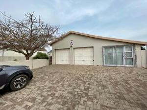 a car parked in front of a house at Langebaan Country Club Self Catering 1A in Langebaan