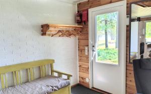 a door to a room with a bench and a window at Villa Dyyni - Oulujärvi Manamansalo in Vaala