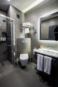 a bathroom with a toilet and a sink and a shower at Educity Hotels & Spa in Istanbul +41 photos
