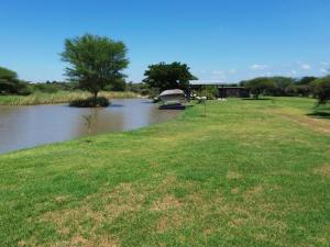 a boat on a river near a grass field at Nonaka in Louis Trichardt