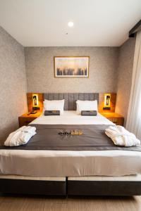 a bedroom with a large bed with two lamps at Educity Hotels & Spa in Istanbul