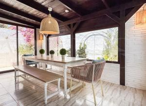 a dining room with a table and chairs on a patio at Marbella House with pool and rooftop terrace REMS in Marbella