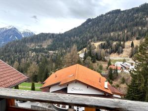 a building with an orange roof on top of a mountain at Elgi Apart in Serfaus