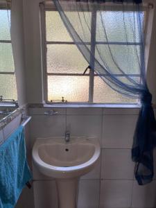 a bathroom with a sink and a window at Alabaster Rest in Johannesburg +12 photos