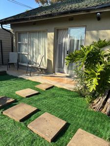 a yard with stepping stones on the grass at Alabaster Rest in Johannesburg