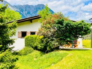 a house on a hill with mountains in the background at Stille Auszeit in Zams