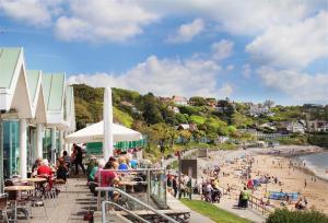 a group of people on a beach with a crowd at Arfryn in The Mumbles
