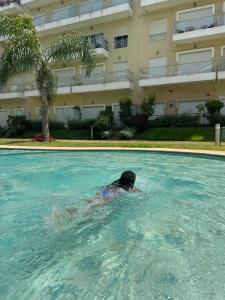 a person swimming in a swimming pool in a building at Résidence kettani in Zemmour Touirza