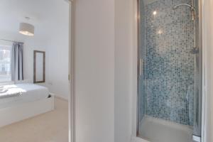 a bathroom with a shower with a glass door at William Gammon Dr in The Mumbles +12 photos