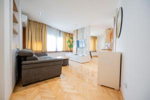 a living room with a couch and a refrigerator at Apartman Simonovic in Vrnjačka Banja