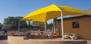 a large yellow umbrella in front of a building at 77 Pendleberry Grove in Warmbaths
