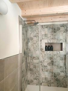a shower with a glass door in a bathroom at ai Parlenti 25 - openspace in Tirano