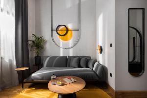 a living room with a couch and a table at IL CONFORMISTA Casa Storica in Thessaloniki +105 photos