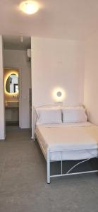 a bedroom with a white bed in a room at Volca Studios ΙΙ in Emporio