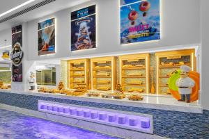 a fast food restaurant with a buffet of food at Pickalbatros Jungle Aqua Park - Neverland Hurghada in Hurghada
