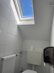 a bathroom with a toilet and a window in it at Greetsieler Börse in Greetsiel +27 photos