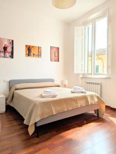 Ένα ή περισσότερα κρεβάτια σε δωμάτιο στο Tuscany Home Montecatini Centro