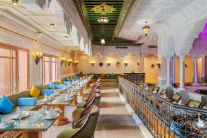 a dining room with long tables and chairs at Pickalbatros Palace - Aqua Park Hurghada in Hurghada