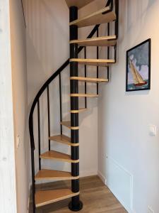 a spiral staircase in a home with white walls at Port Rewa in Rewa