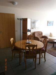 a dining room with a wooden table and chairs at Námshestar in Kuludalsa
