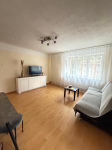 a living room with a couch and a table at Piejūras laivinieks in Liepāja