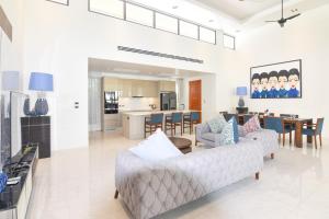 un salon avec un canapé et une table dans l'établissement Breeze Villa - Luxury Relaxation in Phuket, à Ban Thalat Choeng Thale