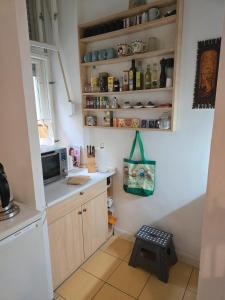 a kitchen with a counter with a microwave and a stool at Appartement Berlin Charlottenburg in Berlin +6 photos