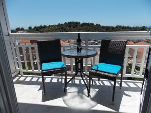 a table and chairs on a balcony with a view at Apartments and Rooms Jasna in Hvar