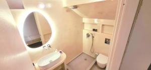 a small bathroom with a sink and a mirror at Volca Studios ΙΙ in Emporio +8 photos