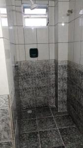 a bathroom with a shower with a window at HOTEL LIVRAMENTO Maceió in Maceió