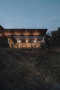 a building with lights on top of a field at Tipai Wildlife Luxuries in Pahāpal +11 photos