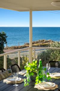 a dining table with a view of the ocean at Absolute Beachfront Escape Family Retreat in Mandurah +191 photos
